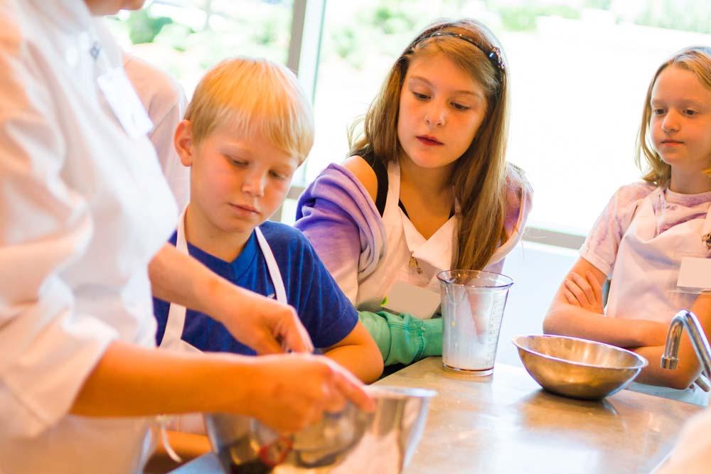 Children watching an adult prepare food