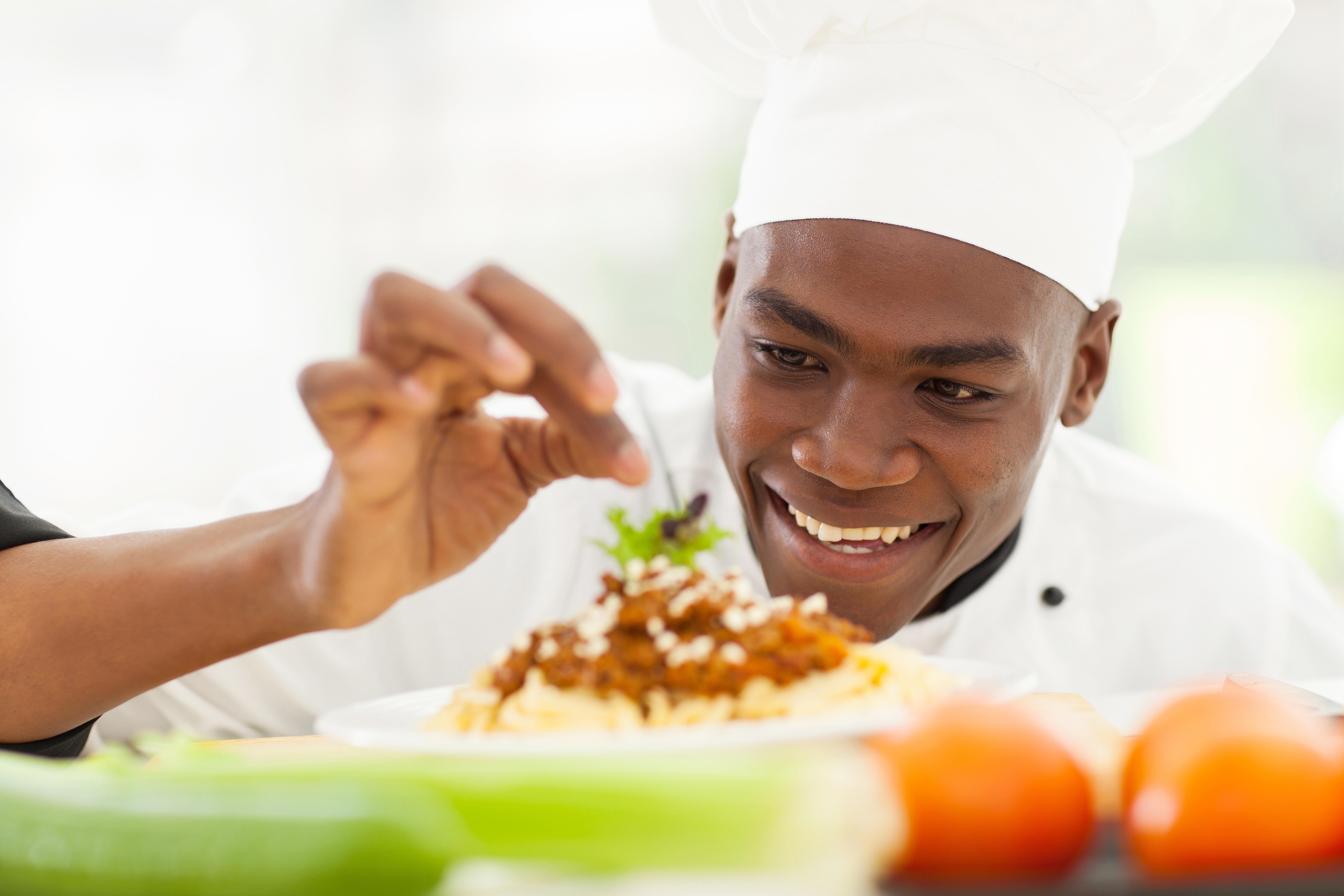 image of male chef looking at brighlty coloured food