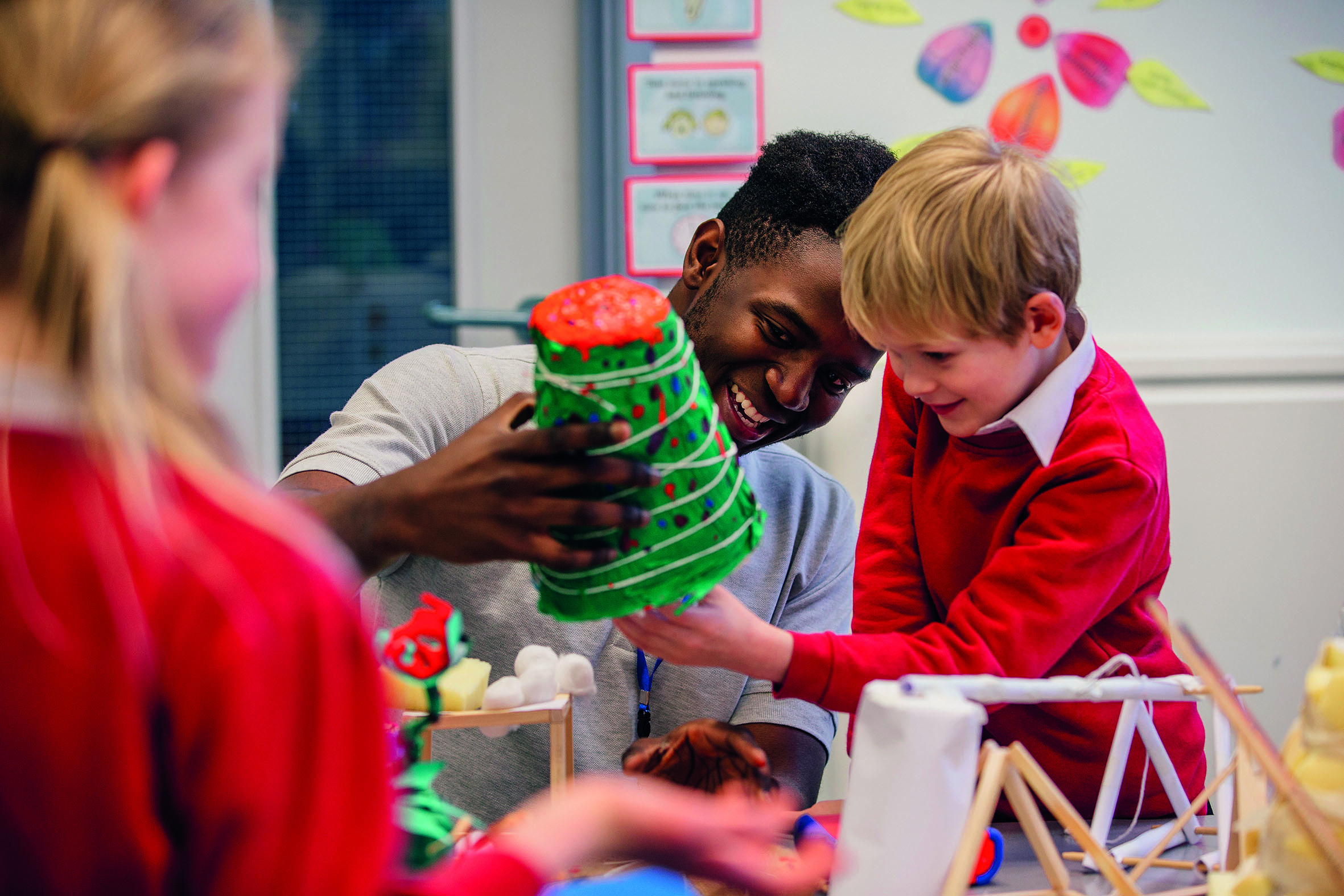 Teacher and child playing with arts and crafts