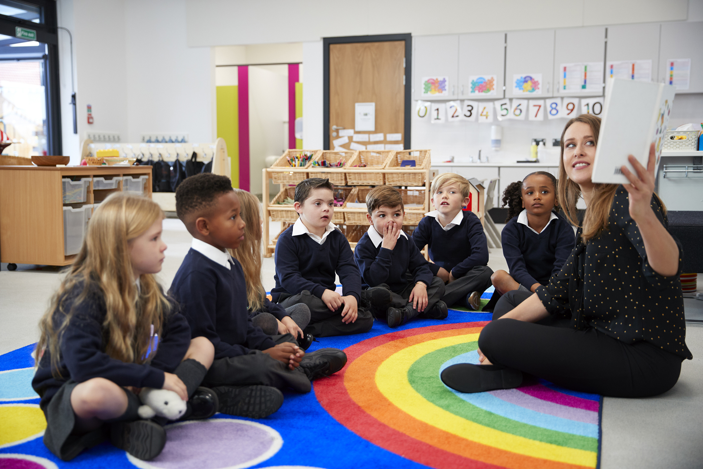 Teacher reading a story to young students